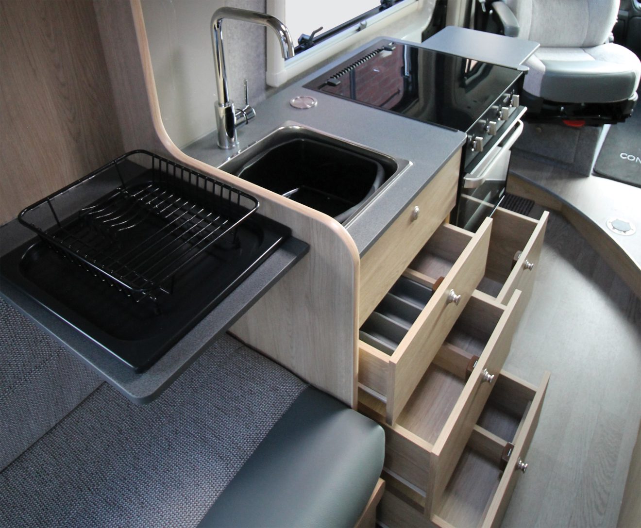 The kitchen storage of the COVE van conversion motorhome.