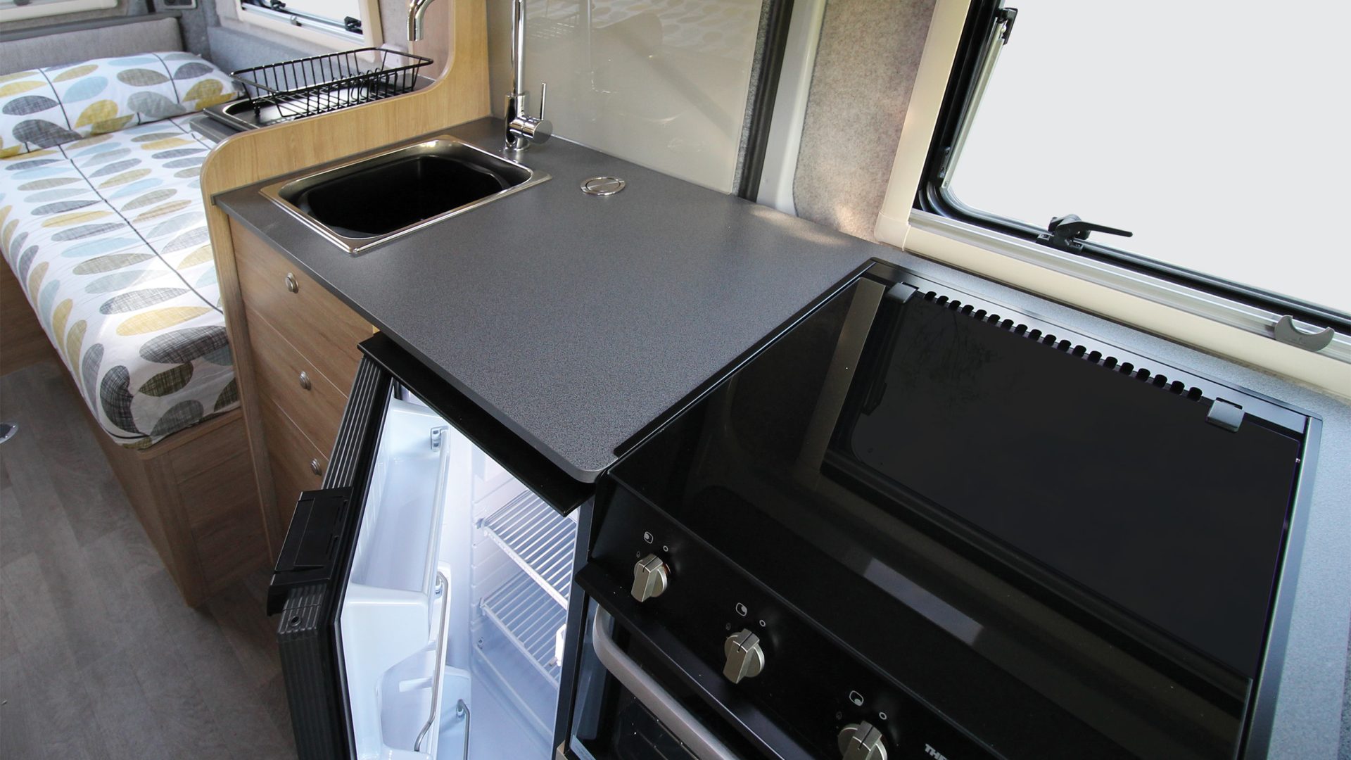 The kitchen with full oven and fridge/freezer.